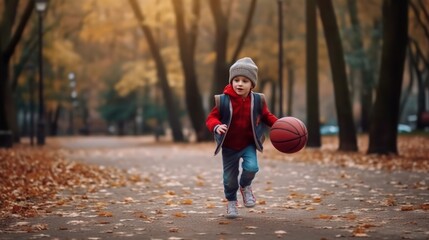 Dribbling small boy plays basketball. Focused cute boy athlete leads the ball in a game of basketball. A boy plays basketball after school.