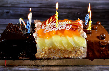 Birthday cake of three different pieces spongy creamy cake for celebrations, hazelnut chocolate...