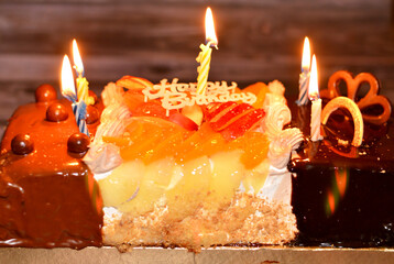 Birthday cake of three different pieces spongy creamy cake for celebrations, hazelnut chocolate...