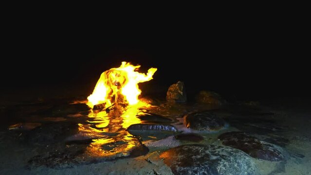 A burning spring in Kalmykia. A source of burning water in the village of Adyk, Russia. A source of fire water. Burning methane in the water. Cold fire. 4K Video