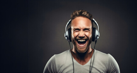 Portrait of a happy young man listening to music with headphones. - obrazy, fototapety, plakaty