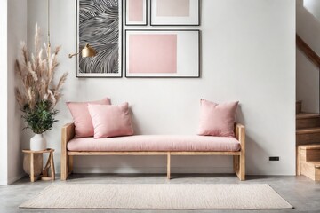 Wooden bench with pink pillows near staircase against white wall with three poster frame. Scandinavian style interior design of modern entrance hall.