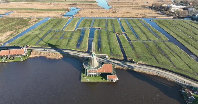 Zaanse Schans Molen 'De Kat', Historic windmill n the dutch polder, touristic attraction destination. Dutch heritage and culture. Birds eye aerial drone view.