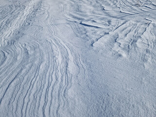 Winter snowdrifts abstract texture of snow shaped by the wind on an empty land