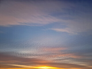Beautiful winter sunset sky background. Colorful dusk clouds
