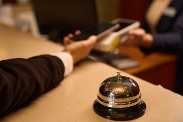 Close up photo of reception bell on desk