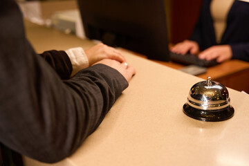 Cropped photo of couple hands lying on reception counter