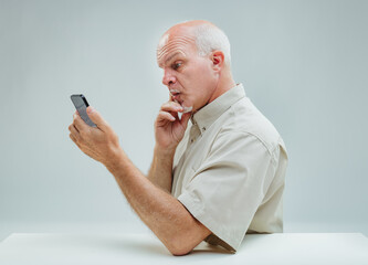 Man's contemplative stance over complex smartphone interaction