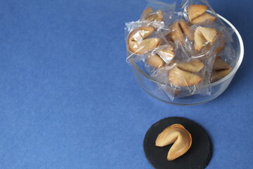 Fortune cookies in a jar bowl on the background of copyspace. Prediction text in cookies. Holiday...