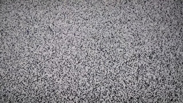 Static TV Noise Overlay Background. Abstract Noise of Analog Television. Black and White Digital Glitch of a Retro TV. Seamless Loop.