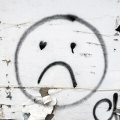 Sad smile painted on the wall