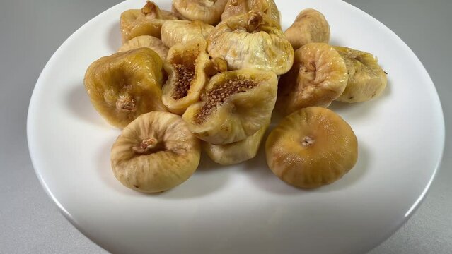 Dried figs on white dish on a gray background