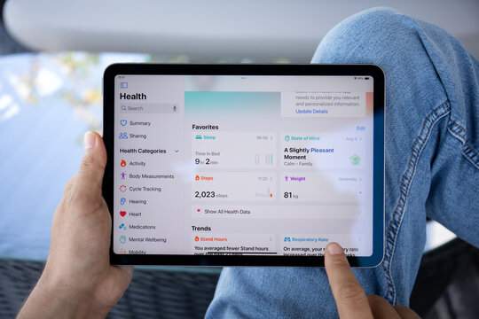 Man hand with Apple iPad Air with app Activity Health