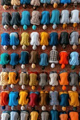 Top view of a diverse group engaged in communal prayer on a patterned carpet
