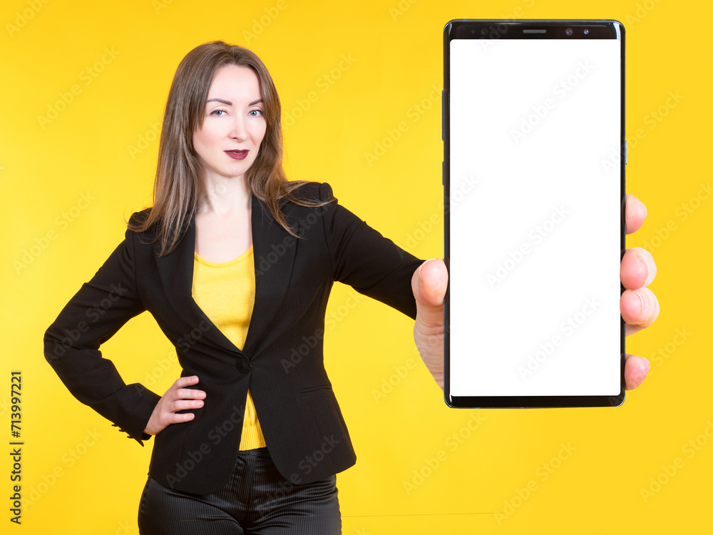 Poster the girl demonstrates a smartphone with an empty screen. a place for text on the mobile phone screen