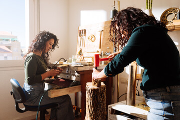 Skilful female jeweller making accessories in workshop