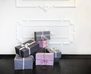Pink and gray gifts with bows on the floor