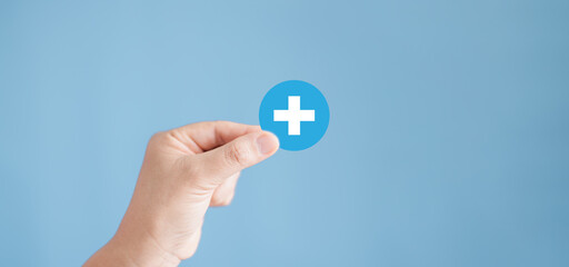Health insurance concept. People hands holding plus and healthcare medical icon, health and access to welfare health concept. Family health care awareness rising growth and clinic, hospital service.