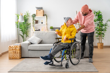 Happy disabled man with a and friend at home