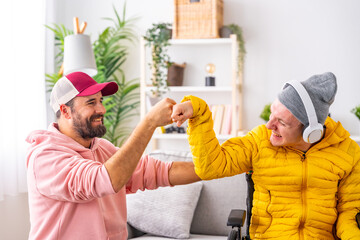 Disabled man and friend giving each other a fist bump - obrazy, fototapety, plakaty