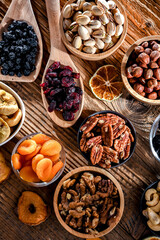 Composition with a variety of dried fruits and assorted nuts.