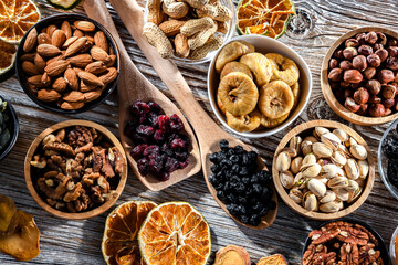 Composition with a variety of dried fruits and assorted nuts.