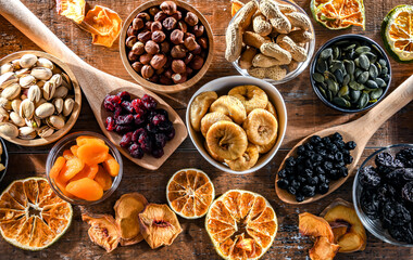 Composition with a variety of dried fruits and assorted nuts. - obrazy, fototapety, plakaty