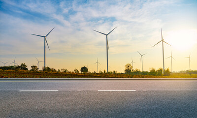 long roads and wind turbine farms behind. clean and renewable energy. Environmentally responsible...
