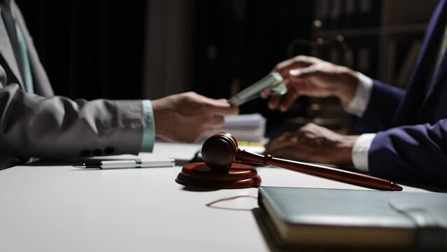 Honest officials or lawyers do not accept and refuse to accept bribes. Anonymous businessman in the dark tries to bribe official or lawyer.