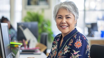Smiling Senior Woman Working at Computer in Modern Office