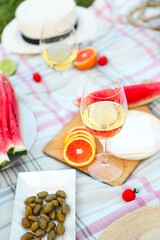 Picnic with white wine on green grass