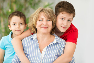 Mid-age woman with two boys indoor