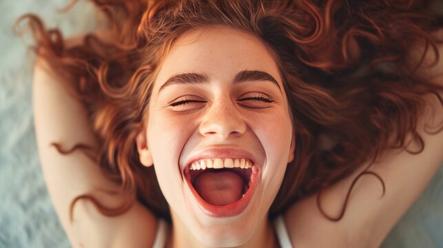 expressive young woman lying down open mouth happy girl enjoying life close up    