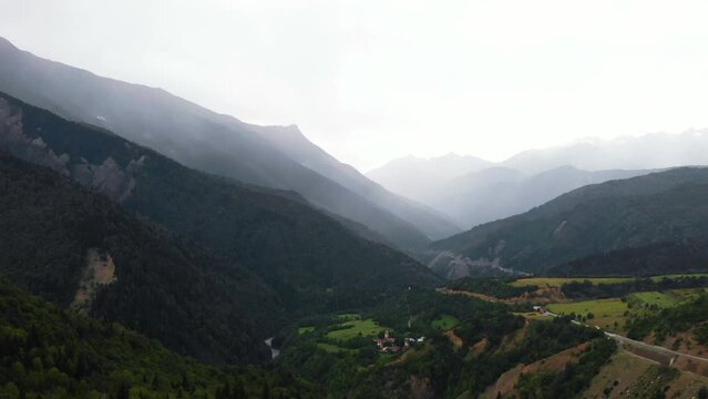 Summer mountain valley, beautifull road way to Mestia. Tsalanari, Hebudi, Georgia. Nature and car travel concept. Asphalt road among the mountains. Aerial view.