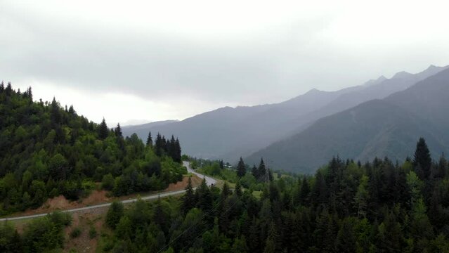 Summer mountain valley, beautifull road way to Mestia. Tsalanari, Hebudi, Georgia. Nature and car travel concept. Asphalt road among the mountains. Aerial view.