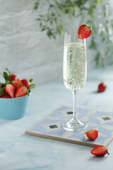 A glass of champagne with strawberries in summer style