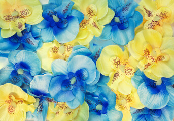 The floral background is made of artificial blue and yellow flowers. The colors of the Ukrainian...