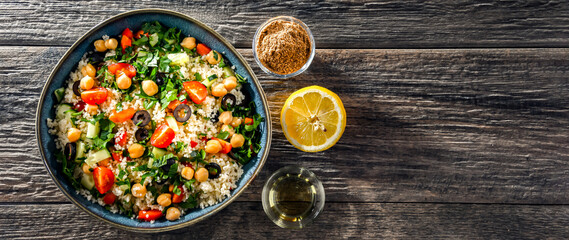 A plate of couscous served with vegetables and chickpeas - obrazy, fototapety, plakaty