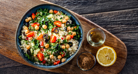 A plate of couscous served with vegetables and chickpeas