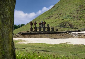 Panoramic view of a group of Moai Statue, perfectly preserved, with red headdress, immersed in the...