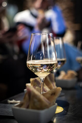 White wine glasses for an aperitif in a night out cocktail bar.