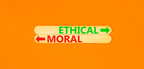 Ethical or moral symbol. Concept word Ethical or Moral on beautiful wooden stick. Beautiful orange...