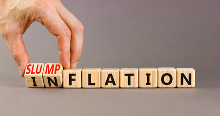 Inflation or slumpflation symbol. Concept word Inflation Slumpflation on beautiful wooden cubes. Beautiful grey background. Businessman hand. Business inflation slumpflation concept. Copy space.