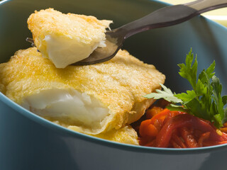 Bacalao rebozado con pimientos rojos. Battered cod with red peppers.
