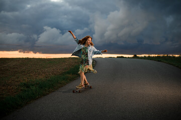 Young woman is smiling sincerely and holding a longboard