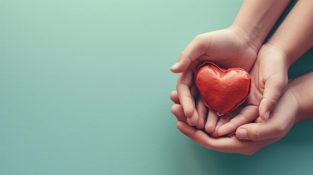 adult and child hands holding red heart on aqua background, heart health, donation, CSR concept, world heart day, world health day, family day 