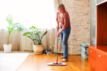 Adult lady cleaning floor at home