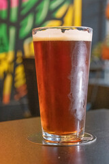 refreshing glass of craft ale ipa beer on table blurred background brew pub