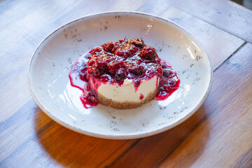 delicious cheesecake dessert with berry jam on side restaurant table