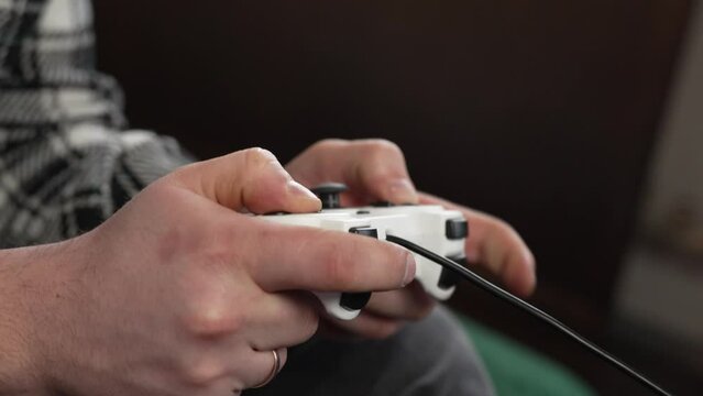 Using controller playing video games - close up of hands and joypad